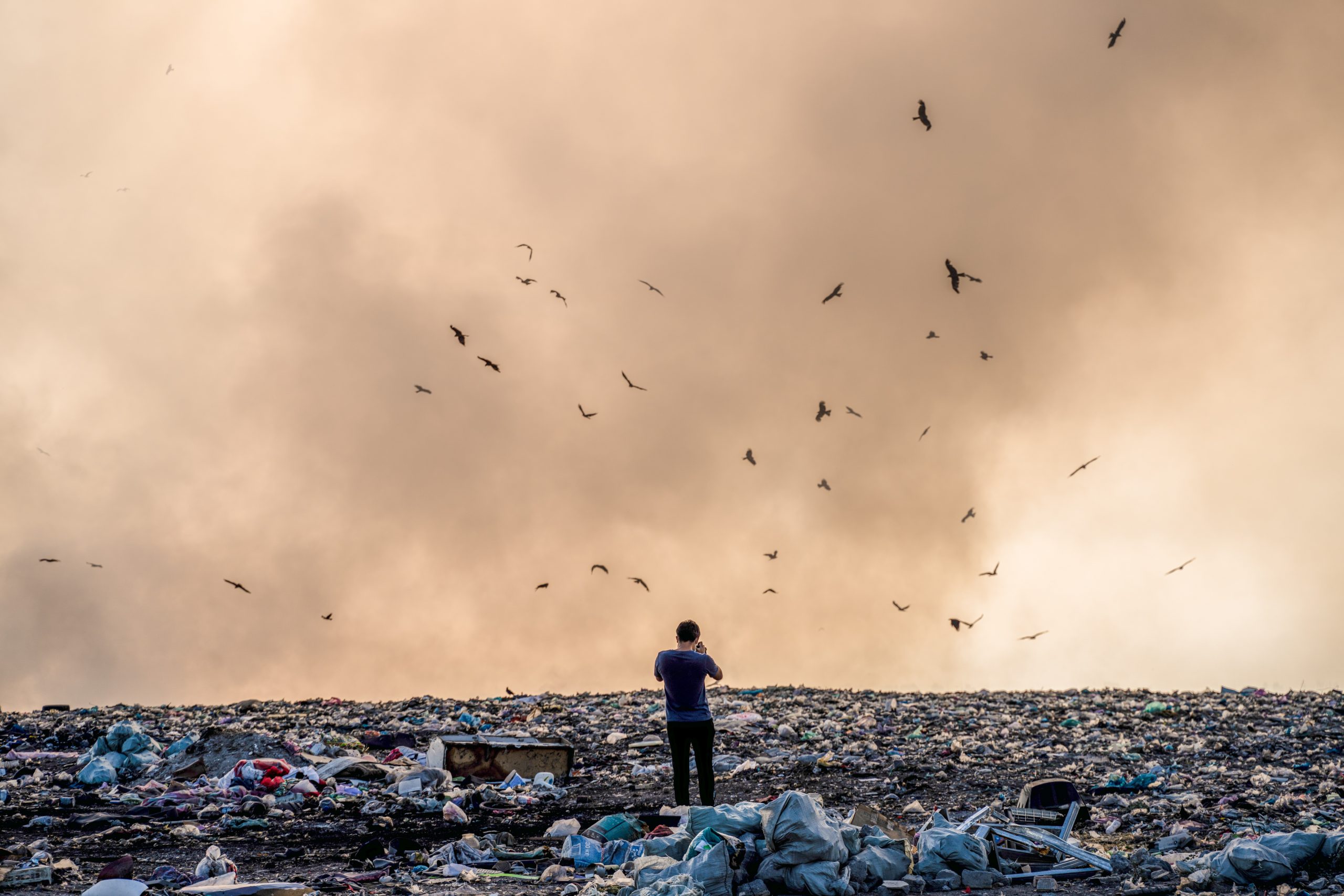 Image of man standing in garbage